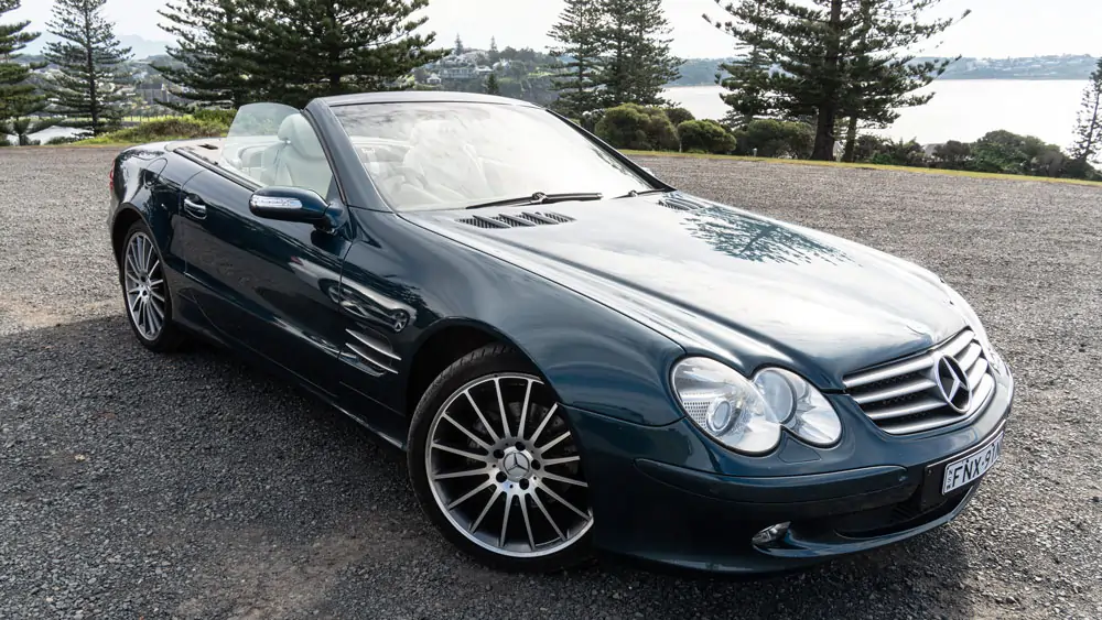 front driver-side view of a black Mercedes-Benz SL350 with roof down