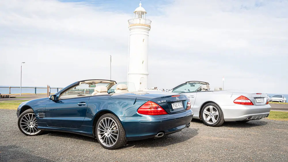 passenger-side view of a two Mercedes-Benz SL350 cars with roofs down